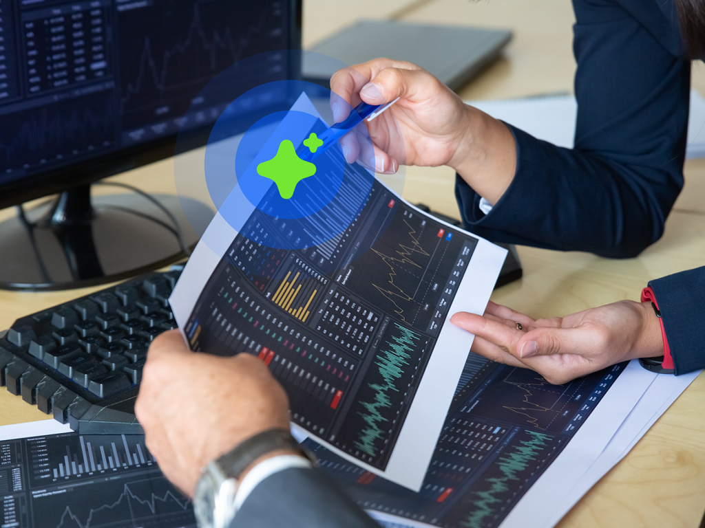 Person holding tablet displaying financial graphs and data.